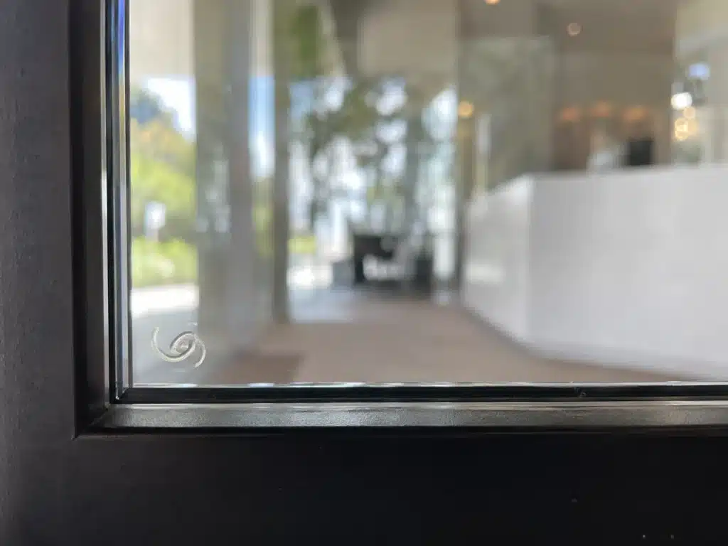 permanent safety glass mark etched in the corner of a glass panel